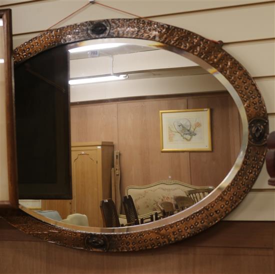 An Arts & Crafts style copper frame mirror, W.98cm